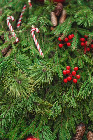 Sparkling Christmas balls and pinecones hang among lush green spruce branches create a joyful winter moodの写真素材