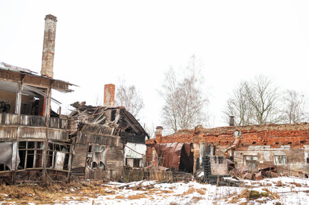 Abandoned ruins with collapsed architecture and crumbling brick in bleak winter landscapeの写真素材