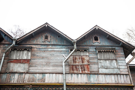 Abandoned wooden facade shows peeling blue timber and weathered texturesの写真素材