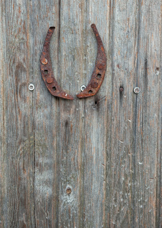 Weathered horseshoe luck on the rustic wood texture vintage backgroundの写真素材