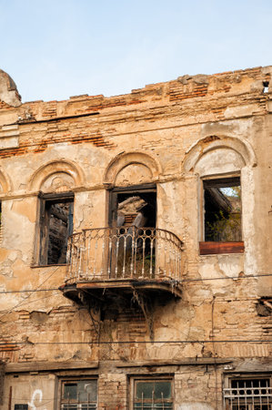 Abandoned weathered building facade with balcony decay architectureの写真素材