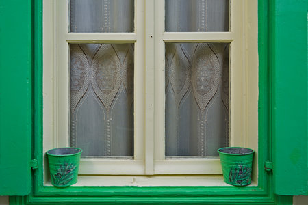 Colorful window with flower pots in the town of Vourliotes