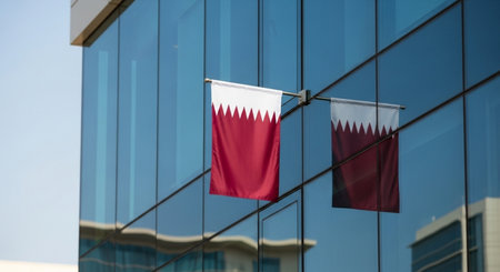 Flag of Qatar on the glass wall of a modern office building.