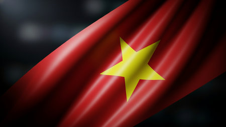 Vietnam waving flag on dark defocused cityscape background.の写真素材