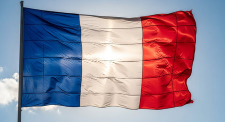 Flag of France waving in the wind against blue sky, close upの写真素材