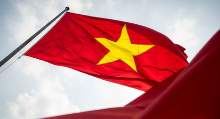 Vietnam flag waving in the wind on blue sky background.の写真素材