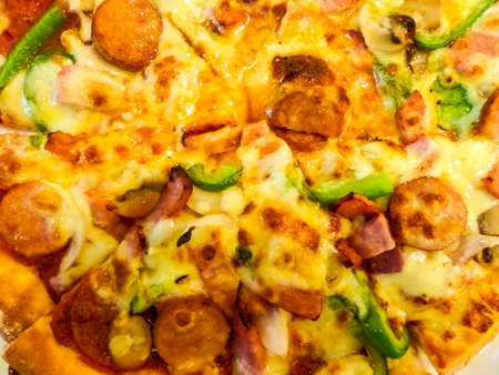 Pizza supreme on top has eight piecesの写真素材