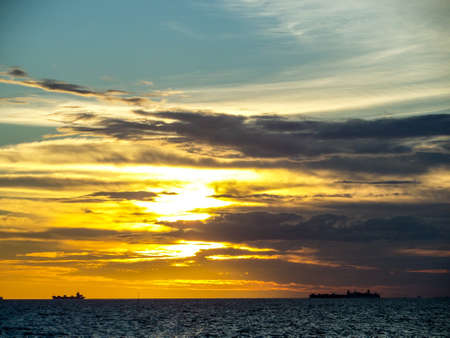 Sunset and dark cloud moving by windの写真素材