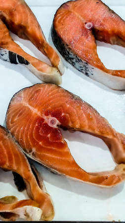 Fresh fish on ice tank at local marketの写真素材