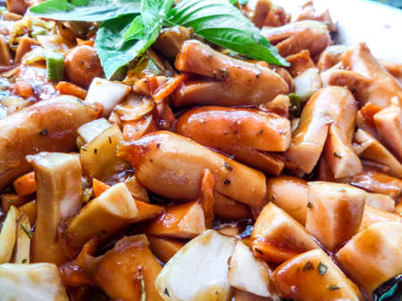 Fried spicy sausage with barbecue sauce. Mix thai and american menuの写真素材