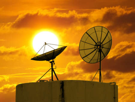 Two satellite disk and sunsetの写真素材