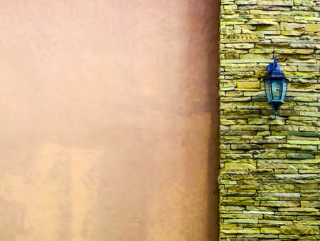 Lamp in middle old rose ancient stone pieces wall at right and smooth wall at leftの写真素材