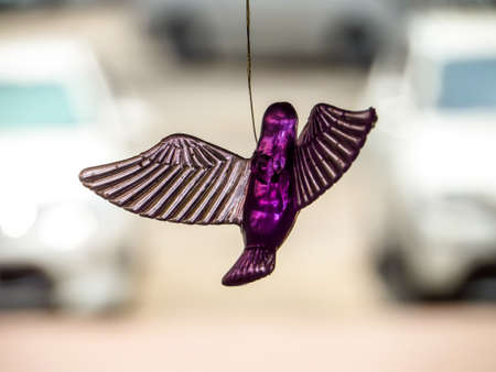 Bird a moblie decoration made of small objects tied to wires or string and hung up so that the objects move when air blows  around themの写真素材