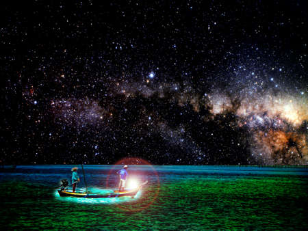 Fishing boat on horizon line between sky and ocean, Element of this image furnished by NASAの写真素材