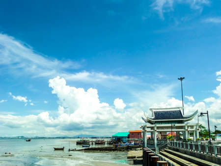 pier fishing boat on the sea blue sky white cloud and parkの写真素材