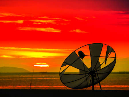 satellite disk break and sunsets on horizonental line at the seaの写真素材
