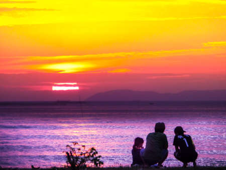 family sitting and look sunset, concept relax, relationship, love, warn, careful, homesickの写真素材