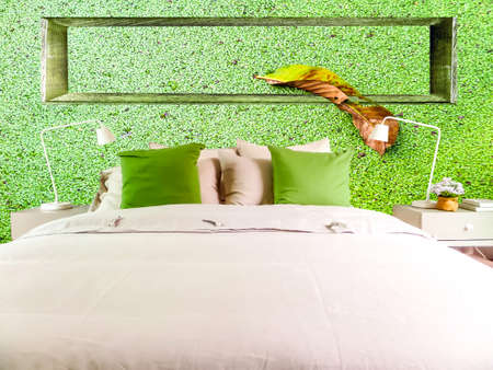 Lamp in middle green ancient stone pieces wall at left and smooth wall at rightの写真素材