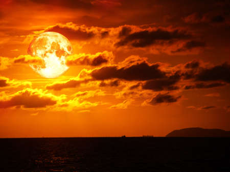 full blood moon and cloud moving in night sky.の写真素材