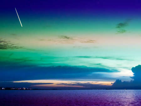meteor fall on dark cloud and cold sky over cityの写真素材