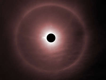 solar eclipse and the rainbow ring around in dark red sky