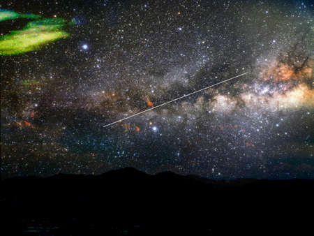 comet silhouette mountain and blur milky way galaxy in nightの写真素材