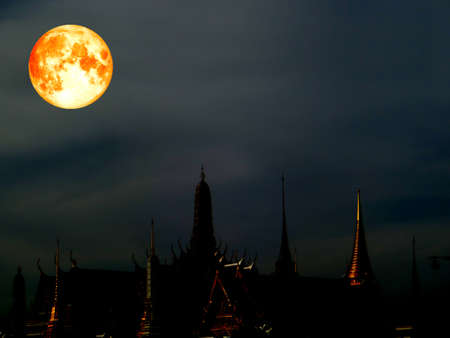 super blood moon over dark sky and silhouette pagodaの写真素材