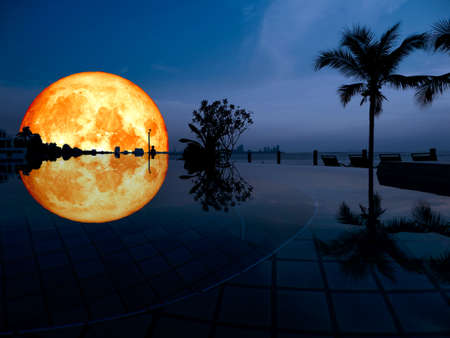 Super full blood moon reflection on the swimming pool.の写真素材