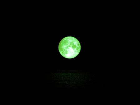 green full moon and light reflection on water surfaceの写真素材