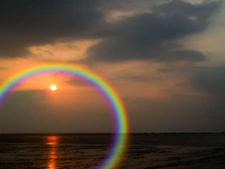 Rainbow and reflection spread cloud of sunset backgroundの写真素材