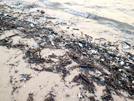 foam plastic bamboo bottle glass garbage and waste pollution on beachの写真素材