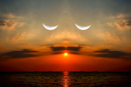 reflection sunset on sea half moon in evening sky, take photo mirror of building and photo look same face close eyeの写真素材