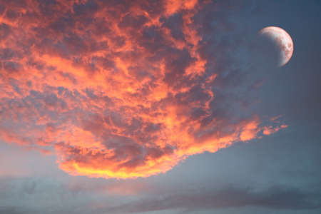 half blood moon and phoenix red blur cloud on sunset sky