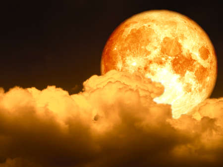 full blood moon and light red heap cloud on night skyの写真素材