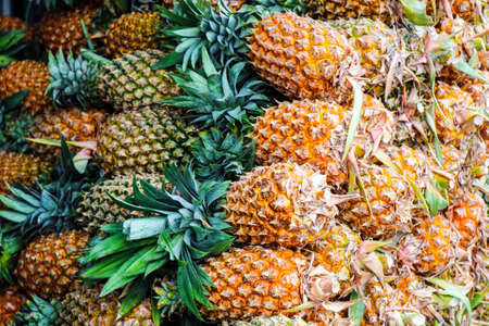 Pineapples group sale on fruit market, Pineapples are tropical fruit that are rich in vitamins