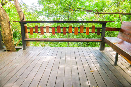 wood bench and table and wood pettern floor and green tree sky gardenの写真素材