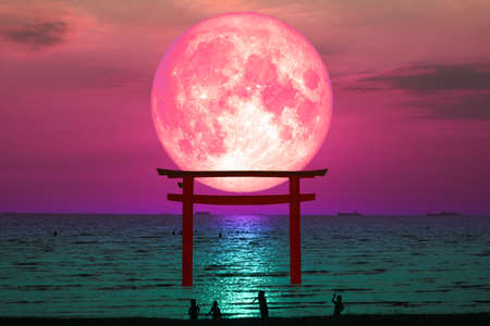 super blood moon silhouette torii wooden Japanese pillar stand on sea night skyの写真素材