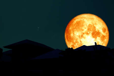 full blood moon back silhouette roof.の写真素材