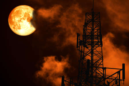 blood moon back silhouette Antenna and night red heap cloud on skyの写真素材