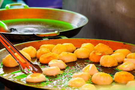 fried Amorphophallus campanulatus ball food by a large pan is thoroughly cooked
