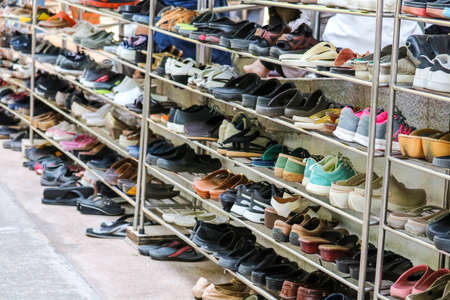 Shoes are organized in an orderly manner on the shelves inside a templeの写真素材
