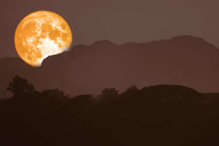 super blood moon back on silhouette mountain on night skyの写真素材