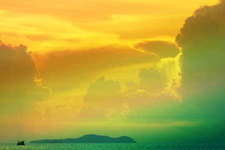 sunset multicolor cloud on silhouette sky fishing boat on island and sea