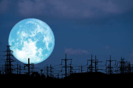 blue milk moon back on silhouette electric pole on night sky