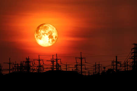 full milk blood moon back on silhouette electric pole on night skyの写真素材