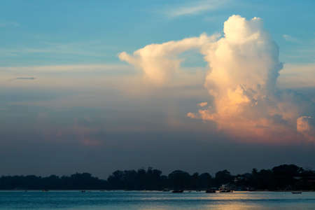white orange sunset cloud sunshine in summer blue sky over seaの写真素材