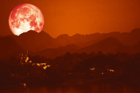 blood moon on night red sky back over silhouette mountainの写真素材