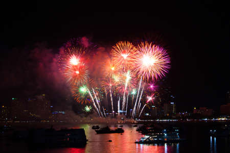 Pattaya city thailand fireworks on beach and reflection color on water surfaceの写真素材