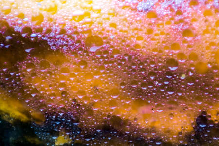 colorful dark and shadow of oil surface background after fried meal and fish. Oil is poured into the water pipe. Without filteringの写真素材