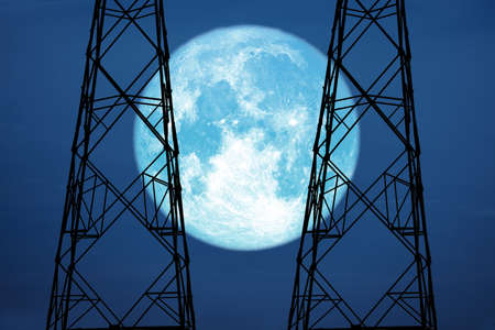 full harvest moon on sky and silhouette power electric poleの写真素材